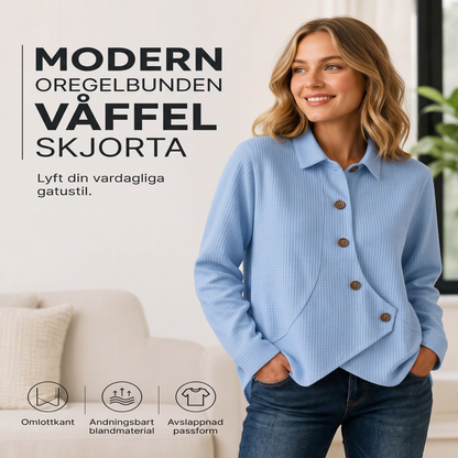 Damstickad topp med oregelbunden fåll och knappar